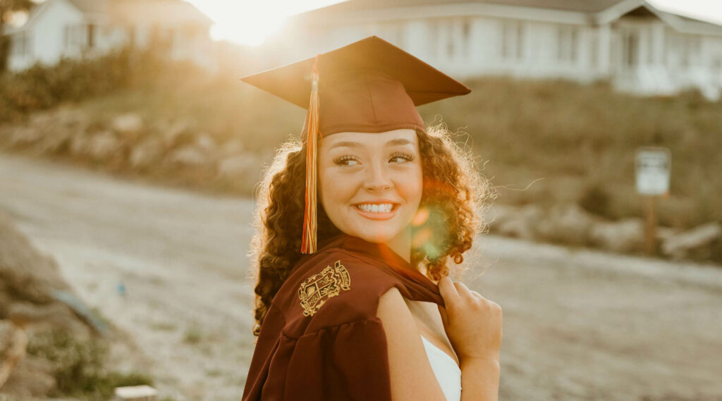 A student poses for their senior photography session, celebrating their high school graduation.